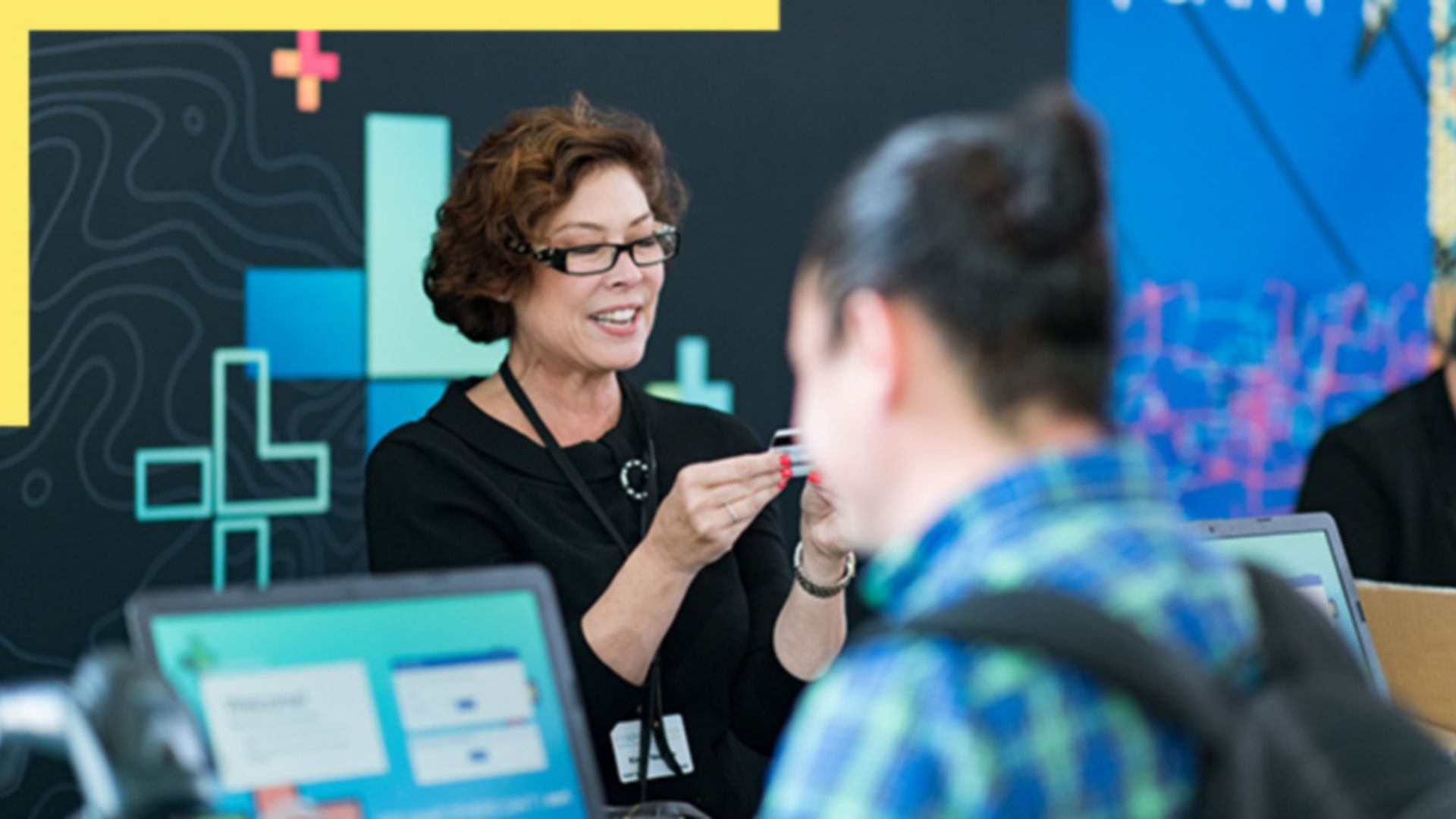 A presenter leading a GIS tutorial at a conference