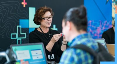 Woman helping attendees at the Esri User Conference