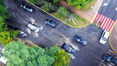 Aerial view of cars driving on a flooded road
