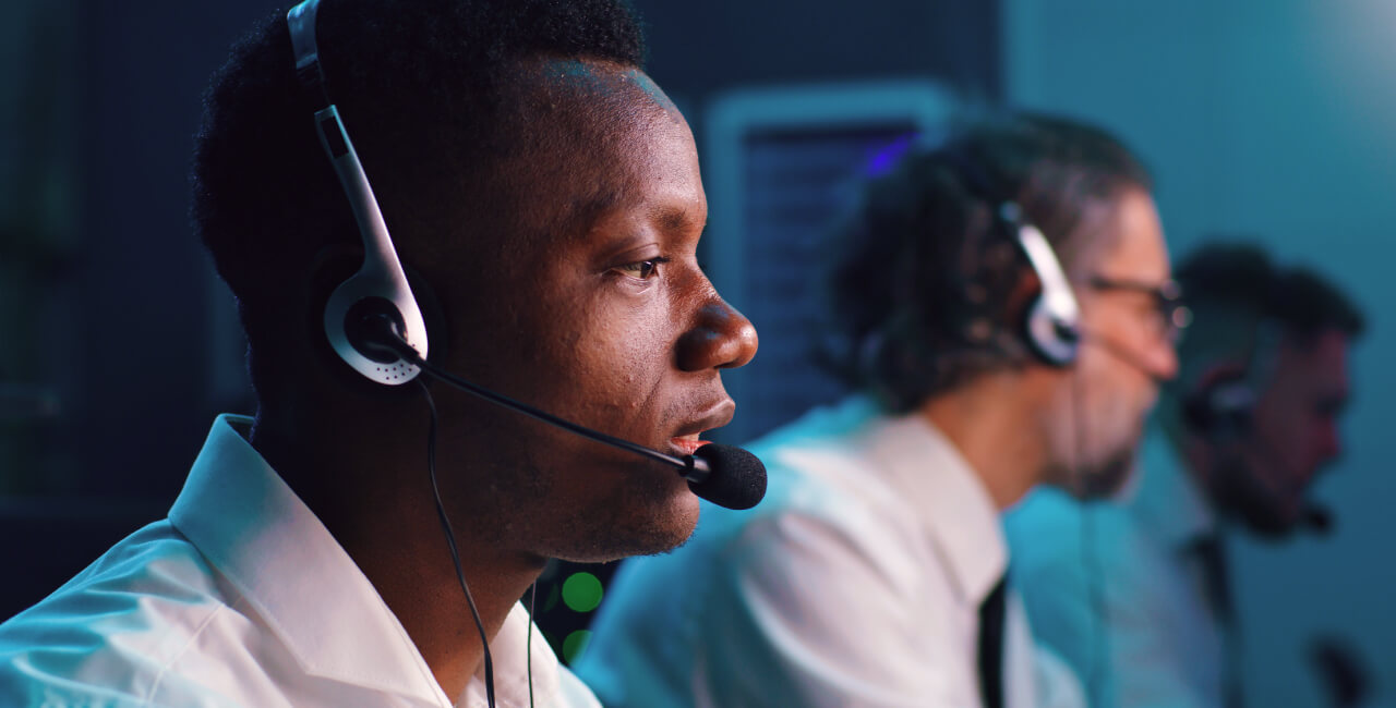 A photo of a telecommunicator working at a PSAP (Public Safety Answering Point). 