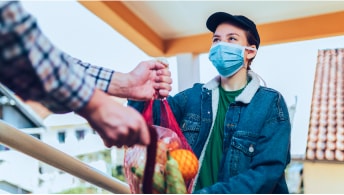 A person buying fruit from the grocery store at the cashier station
