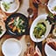 Plates of food on a restaurant tabnle, photographed from above