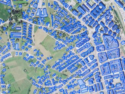 Aerial view of an urban area with blue outlines marking building footprints
