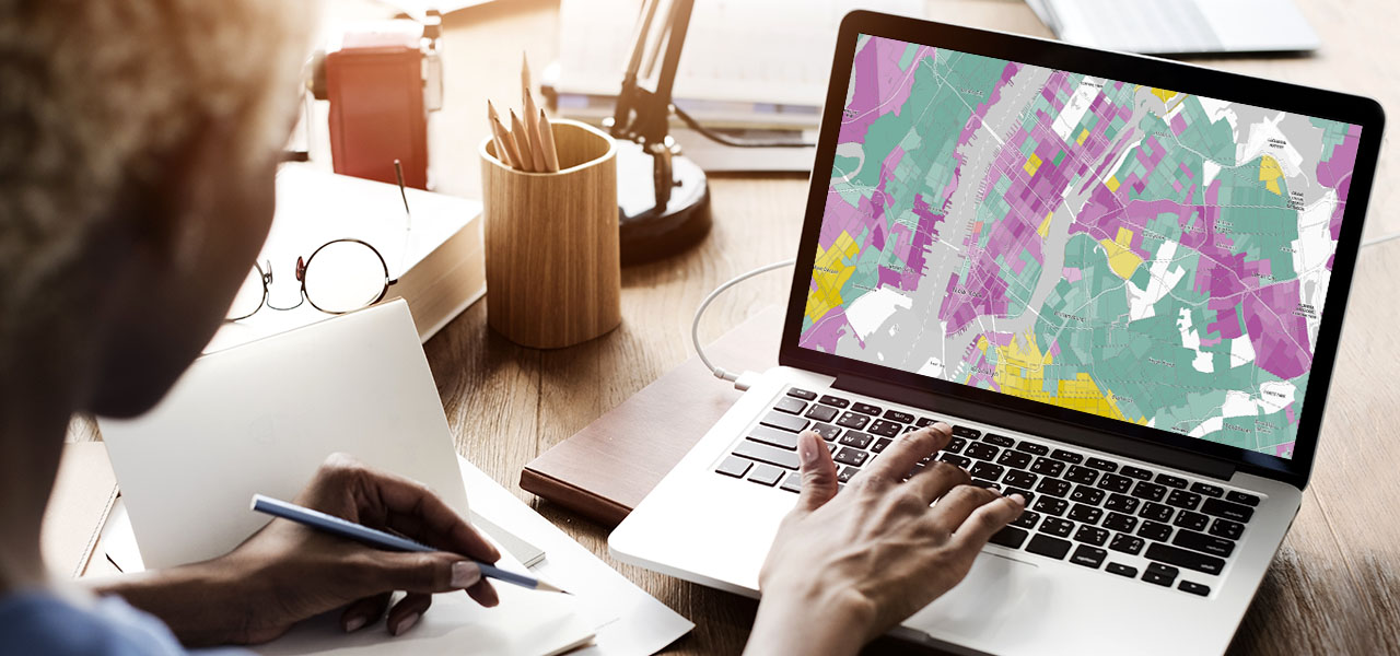Photo of a person using a heat map on a laptop in a brightly-lit home office environment