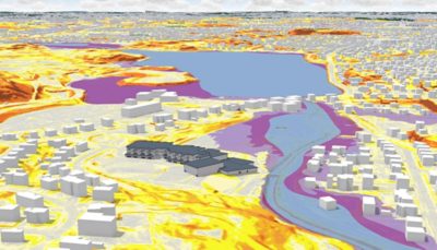 A 3D computer model of a city, with different colored zones (yellow, orange, pink, and blue) and white buildings.
