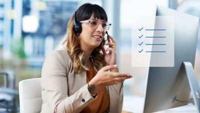 A customer service representative wearing a headset smiles as she talks with a customer on the phone and gestures with her hand. A graphic overlaid on the image shows a checklist with four checkmarks.