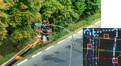 A photo of a utility worker using an aerial work platform to reach a streetlight, overlaid with a street heat map