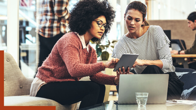 Two people looking at a tablet computer together