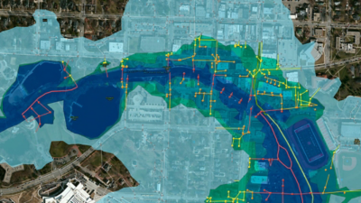 City flood zone map, showing water levels impacting infrastructure like power lines around buildings/stadium.