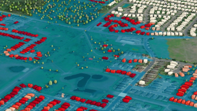 Aerial view of a neighborhood with red roofs and blue flood zones