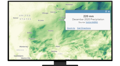 A desktop computer monitor displaying a precipitation map of Texas