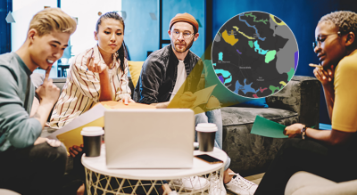  A group of people looking at a laptop on a table overlaid with an image of a multicolored map