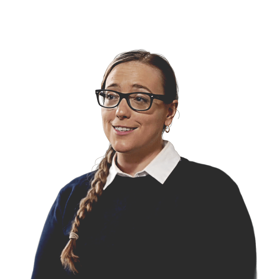 Molly Burhans, GIS advisor to the Vatican, wearing a sweater and glasses in front of sand dunes